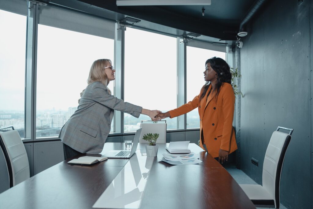 Two women shaking hands: outsourced business development